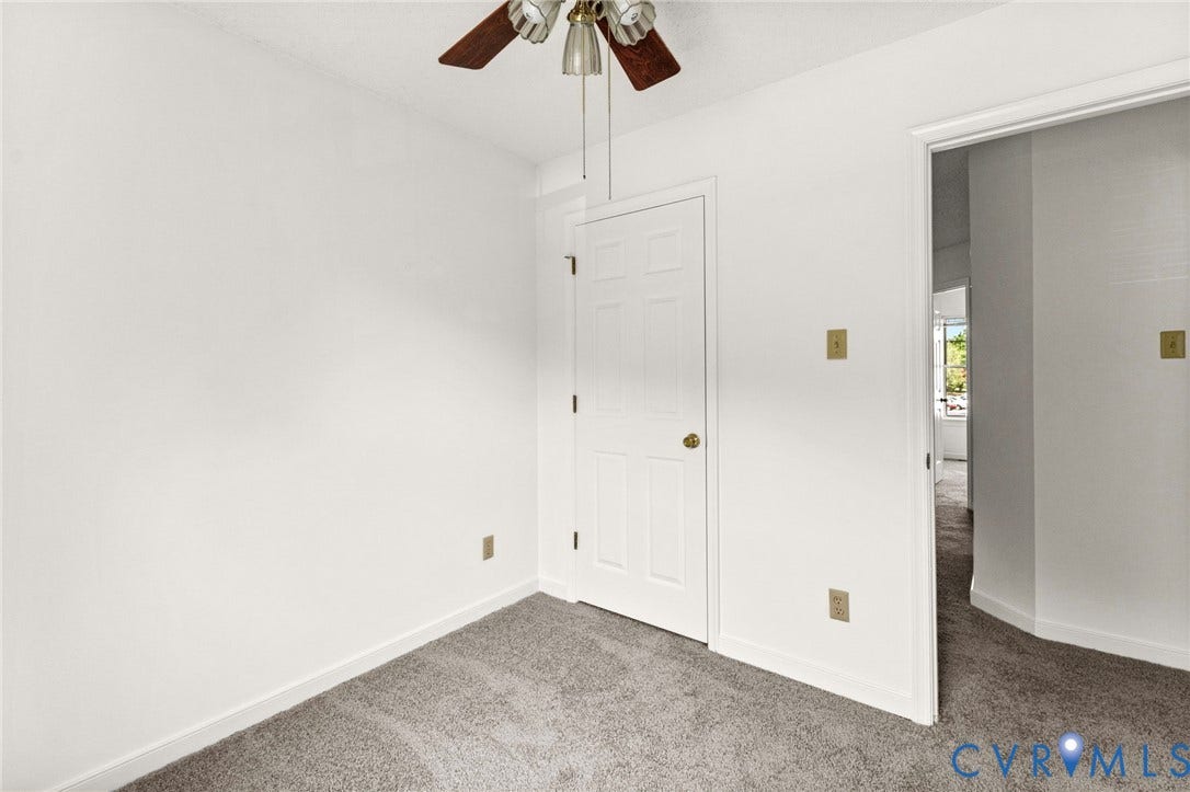 10111 Robin Lee Lane, Henrico, VA 23060 Light gray carpeting with a simple white door and ceiling fan