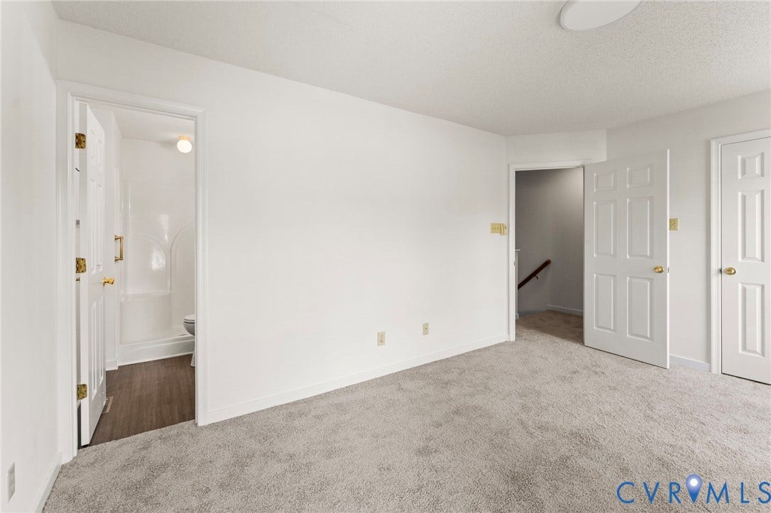 10111 Robin Lee Lane, Henrico, VA 23060 Spacious carpeted bedroom featuring multiple closet spaces with white six-panel doors and brass hardware, abundant natural light from recessed ceiling fixtures, and neutral wall finishes throughout