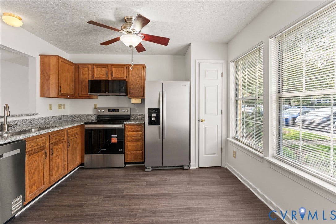 10111 Robin Lee Lane, Henrico, VA 23060 Kitchen featuring wood cabinetry, stainless steel appliances, speckled countertops, and wood-finish flooring