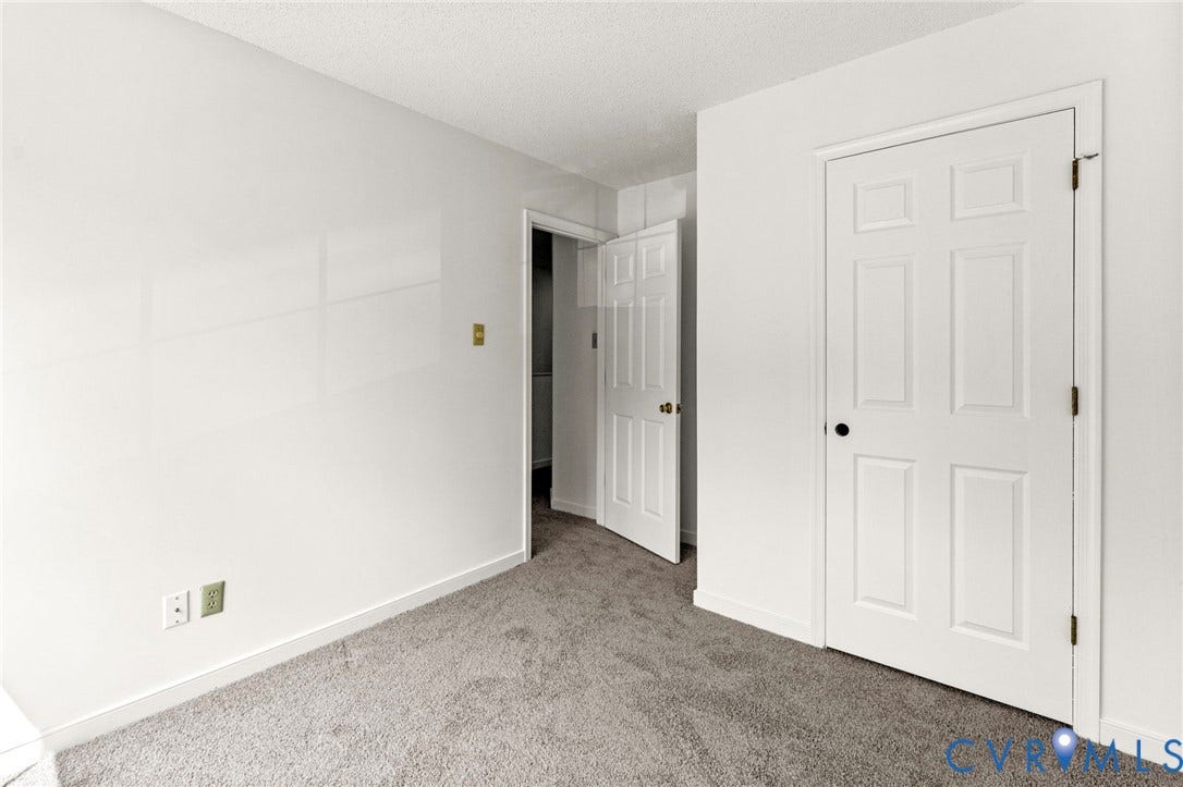 10111 Robin Lee Lane, Henrico, VA 23060 Spacious bedroom featuring neutral carpeting, dual six-panel closet doors, and clean white walls with electrical outlets