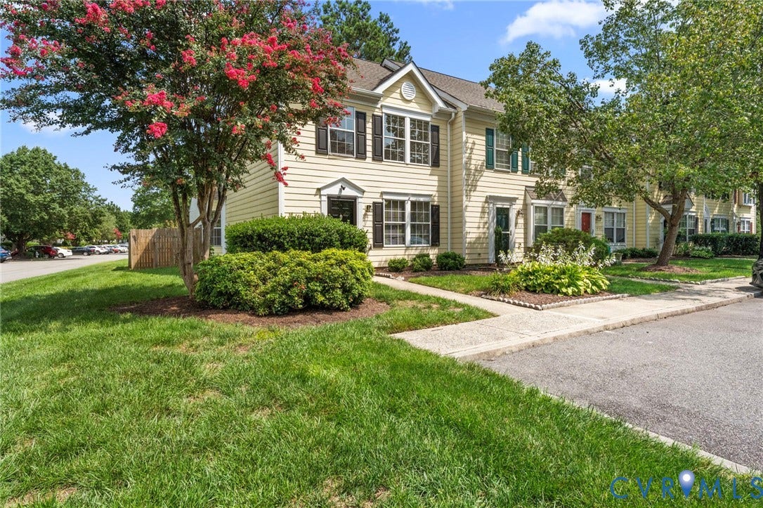 10111 Robin Lee Lane, Henrico, VA 23060 Siding exterior with dormer window detail, featuring mature trees and established landscaping, with a concrete walkway leading to the entrance