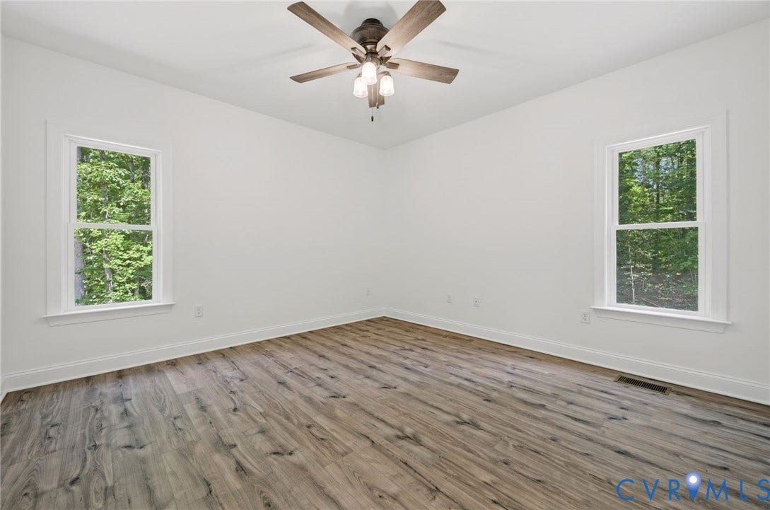 6995 Jefferson Highway, Louisa, VA 23117 Spacious room featuring wood-finish flooring, white trim, and a ceiling fan with integrated lighting