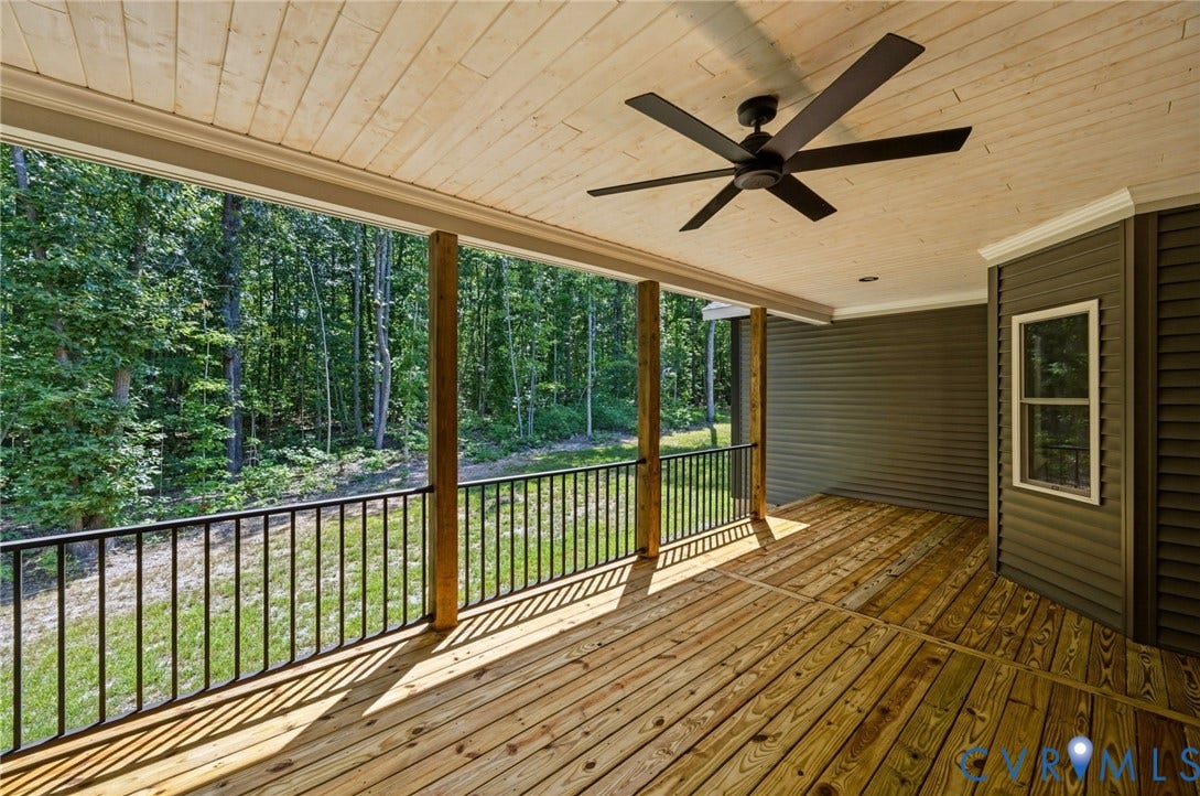 6995 Jefferson Highway, Louisa, VA 23117 Spacious covered deck featuring natural wood flooring, a wood-paneled ceiling, and a large ceiling fan