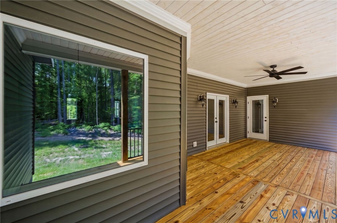 6995 Jefferson Highway, Louisa, VA 23117 Spacious screened porch featuring natural wood flooring, a ceiling fan, and two sets of double French doors
