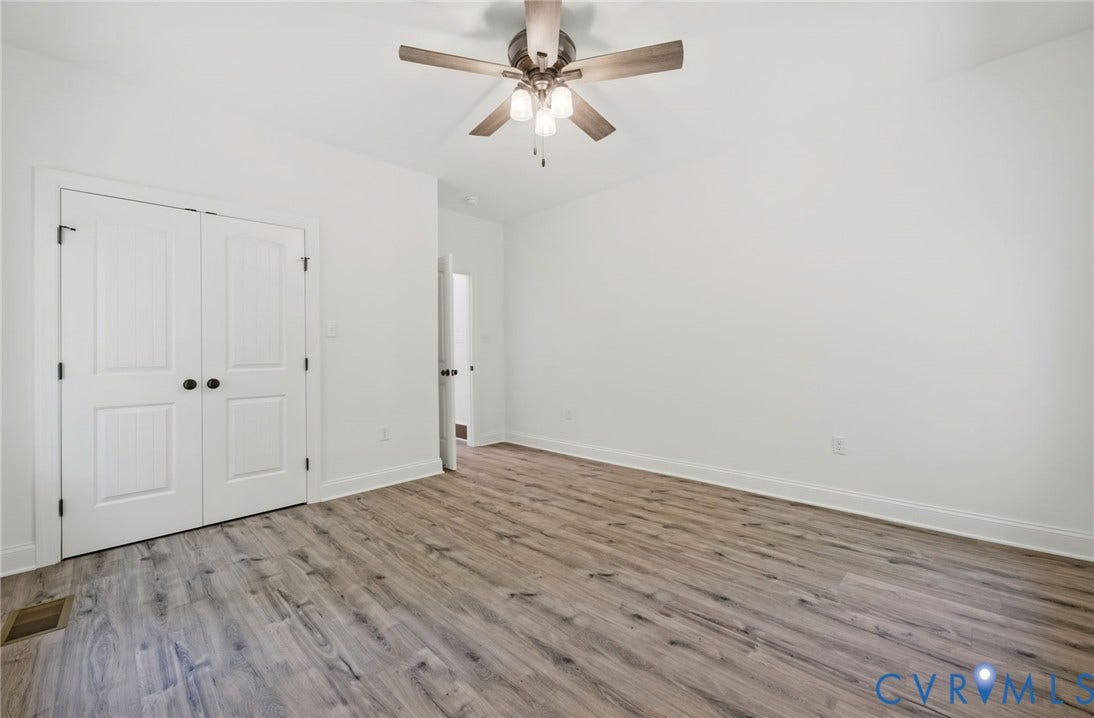 6995 Jefferson Highway, Louisa, VA 23117 Spacious room featuring wood-finish flooring, white baseboards, and a ceiling fan with integrated lighting