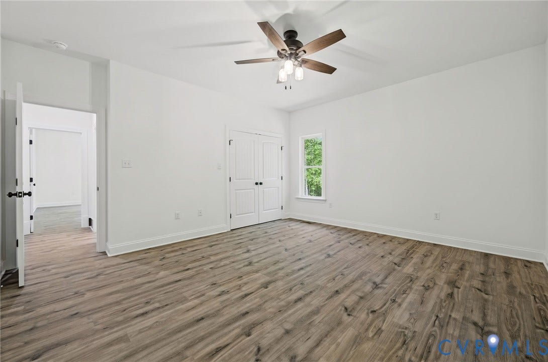 6995 Jefferson Highway, Louisa, VA 23117 Spacious room featuring wood-finish flooring, white walls, and a ceiling fan with integrated lighting