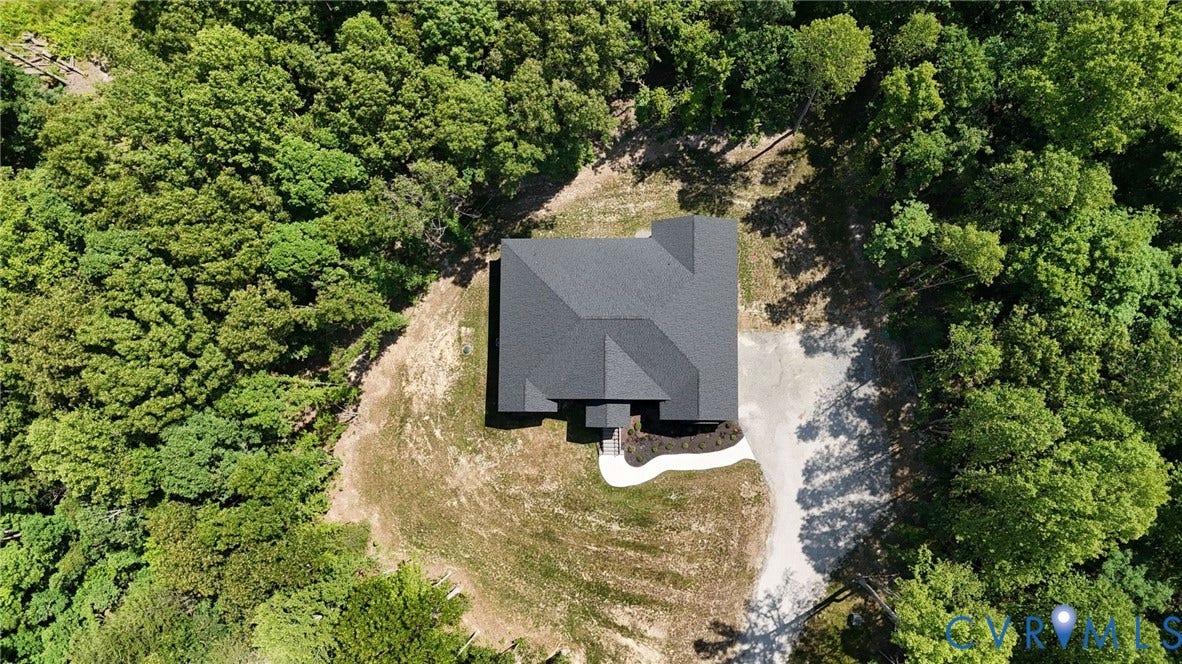 6995 Jefferson Highway, Louisa, VA 23117 Aerial property view featuring a dark gray shingle roof, surrounded by mature green trees