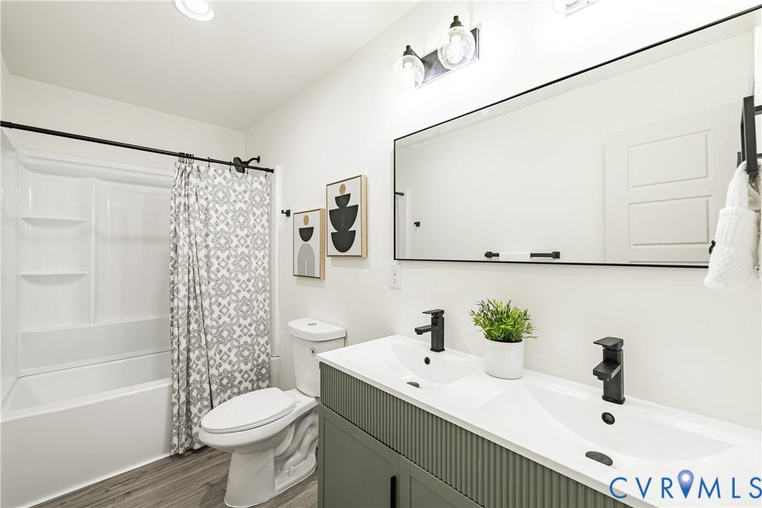 1514 Custer Street, Richmond, VA 23222 Double vanity featuring white sinks, matte black faucets, and a fluted sage green cabinet