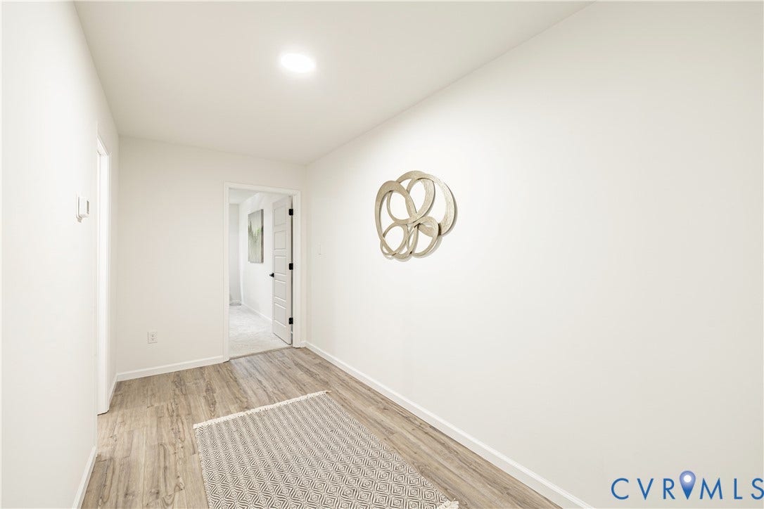 1514 Custer Street, Richmond, VA 23222 Recessed ceiling lighting illuminates a hallway featuring wood-finish flooring and white baseboards