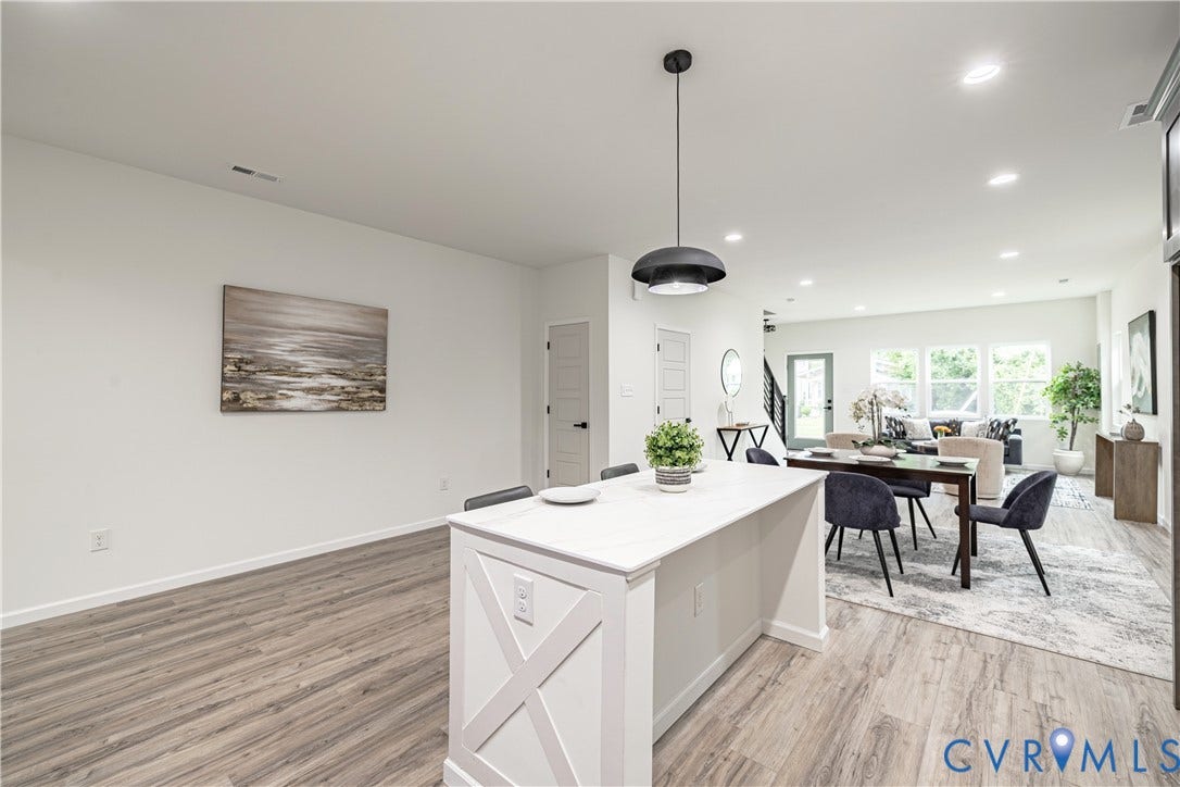 1514 Custer Street, Richmond, VA 23222 Open-concept living space featuring wood-finish flooring, a kitchen island with seating, recessed lighting, and a modern pendant light fixture
