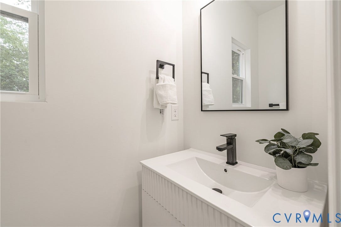 1514 Custer Street, Richmond, VA 23222 Contemporary bathroom vanity with integrated sink, matte black faucet, and coordinating framed mirror