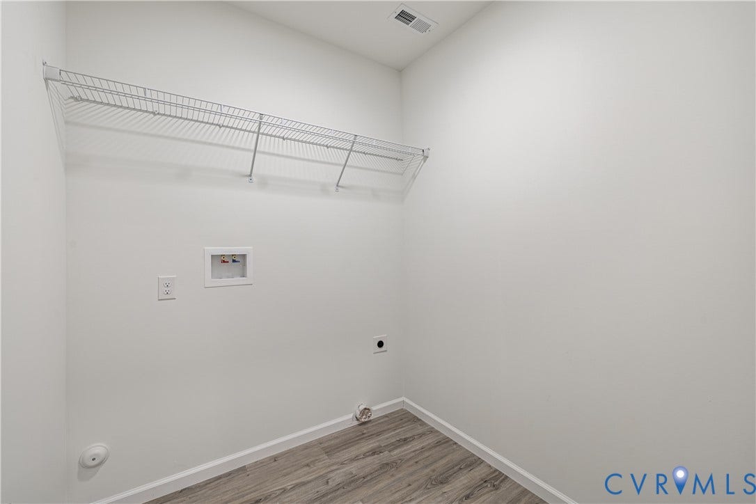 1514 Custer Street, Richmond, VA 23222 Dedicated utility space featuring wire shelving, appliance hookups, and wood-finish flooring