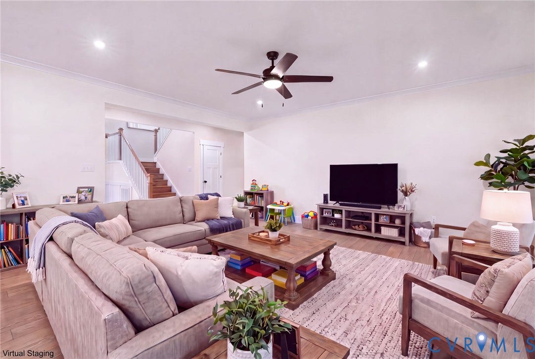 **Virtually Staged**
Recessed lighting, crown molding, wood-finish flooring, staircase with wood handrail, ceiling fan with integrated lighting