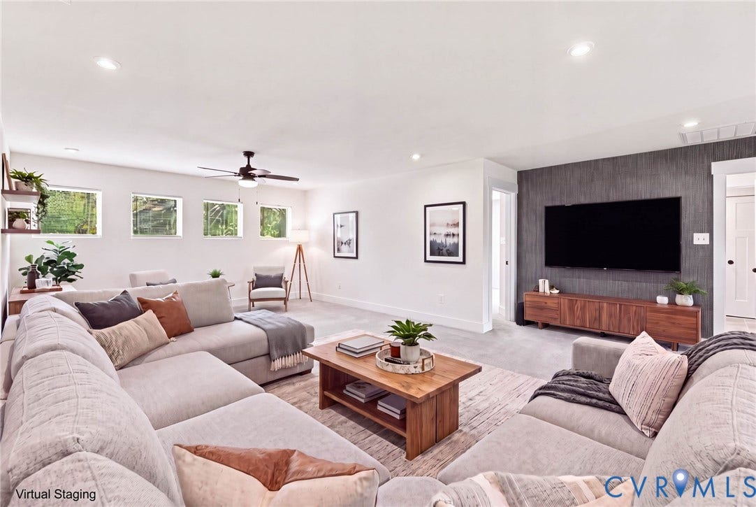 **Virtually Staged**
Recessed lighting throughout, accent wall with textured finish, ceiling fan, multiple windows providing natural light, and wood-finish flooring