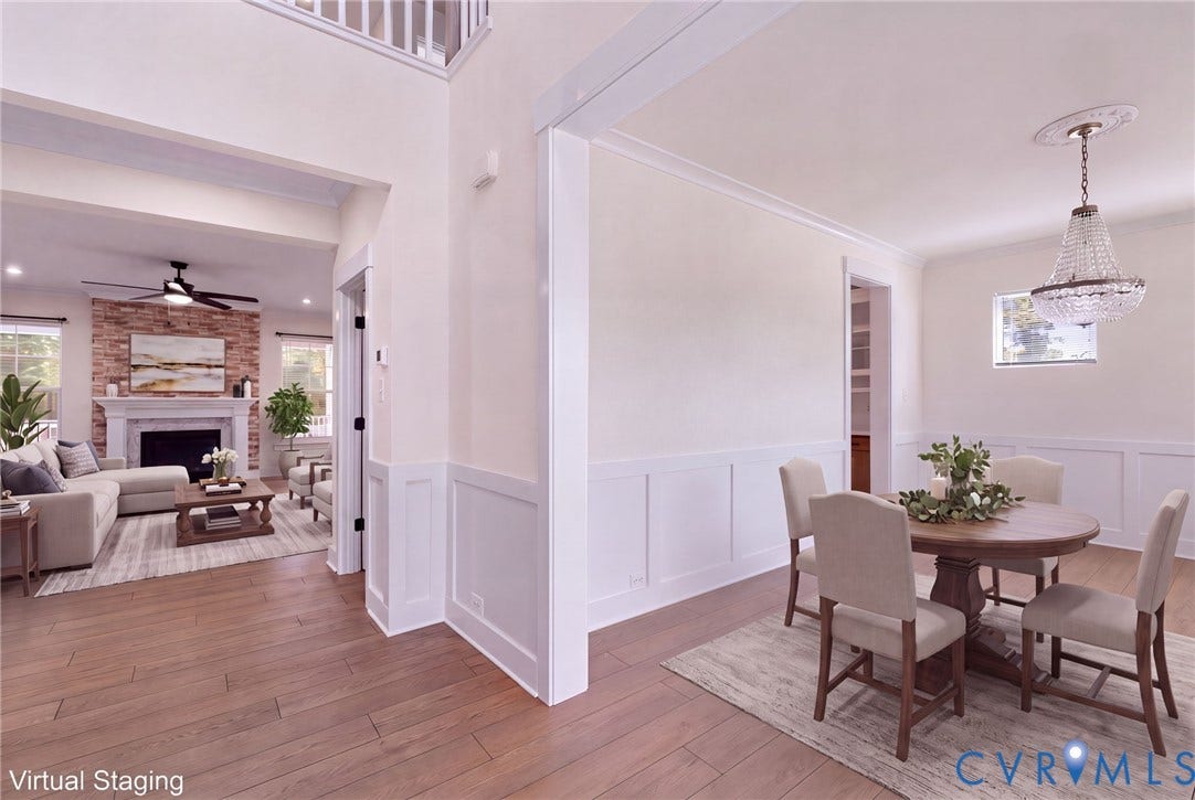 **Virtually Staged**
Wood-finish flooring, wainscoting, crown molding, double-height ceiling, and a crystal chandelier