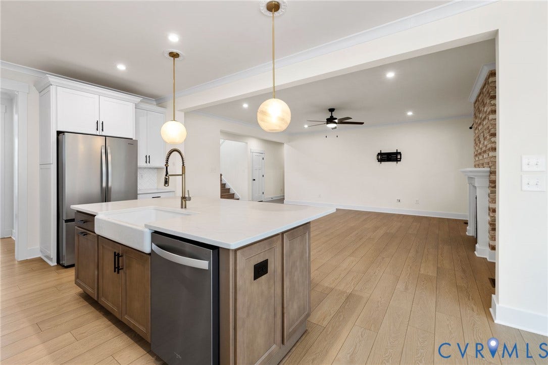 Kitchen island with a farmhouse sink and two pendant lights