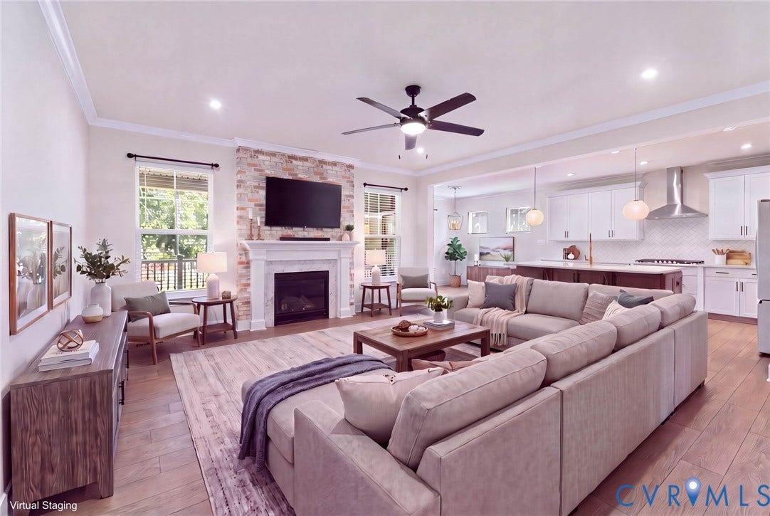**Virtually Staged**
Open-concept living space with wood-finish flooring, a stone-accented fireplace, recessed lighting, and a ceiling fan