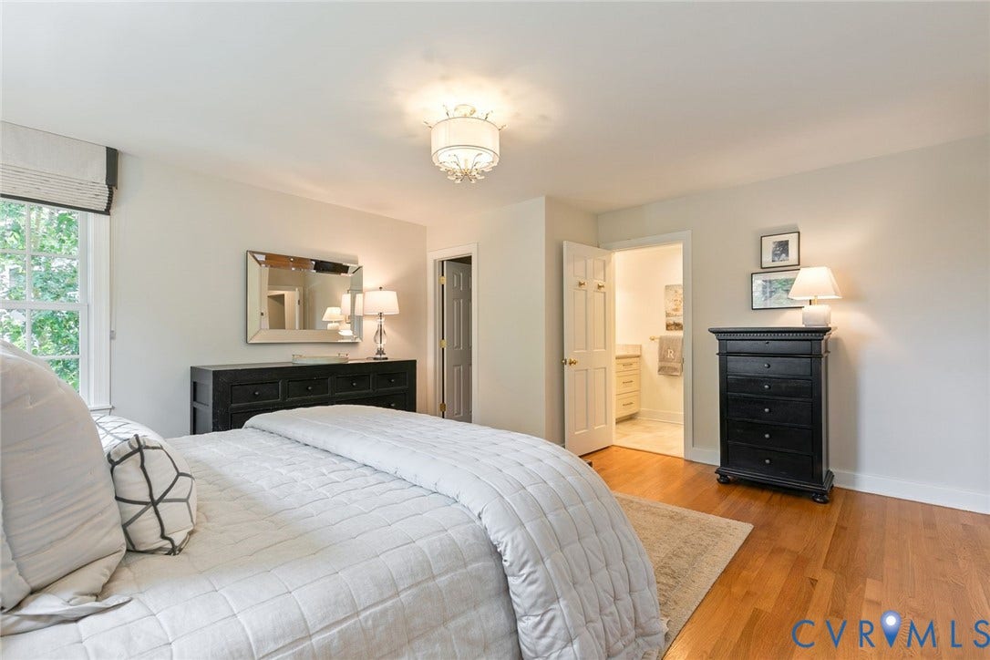 14 Libbie Avenue, Libbie/Grove, Richmond, VA 23226 Spacious room with wood-finish flooring, a decorative ceiling fixture, and a large window with privacy shades