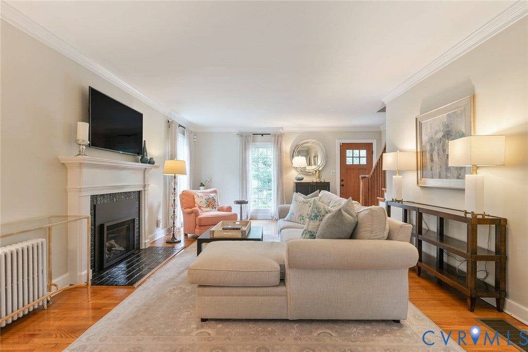 14 Libbie Avenue, Libbie/Grove, Richmond, VA 23226 Living space featuring hardwood flooring, a fireplace with a dark tile surround and a substantial white mantel, crown molding, and generous natural light from a large window