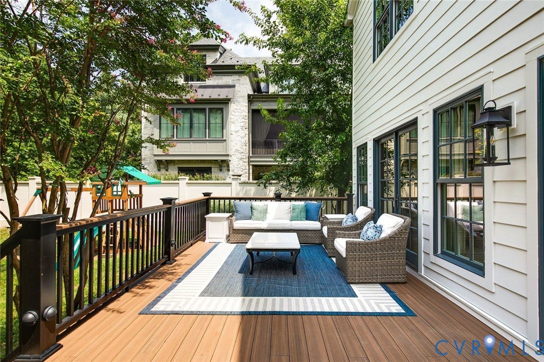 14 Libbie Avenue, Libbie/Grove, Richmond, VA 23226 Expansive wood-finish deck featuring dark railings, a white siding exterior, and multiple glass-paned doors