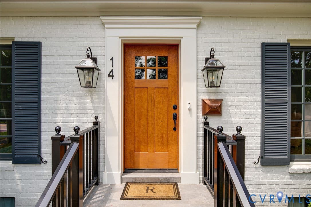 14 Libbie Avenue, Libbie/Grove, Richmond, VA 23226 White brick facade with dark louvered shutters and a natural wood-finish entry door featuring glass panes