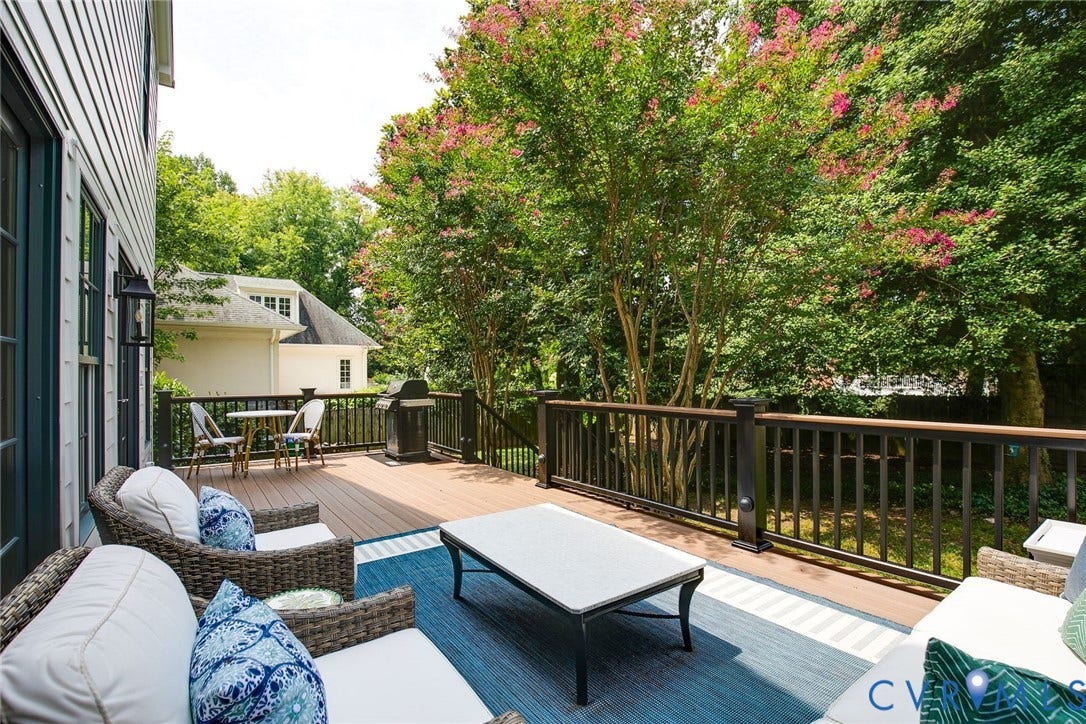 14 Libbie Avenue, Libbie/Grove, Richmond, VA 23226 Spacious outdoor deck featuring wood-finish flooring, dark railings, and mature trees providing natural screening