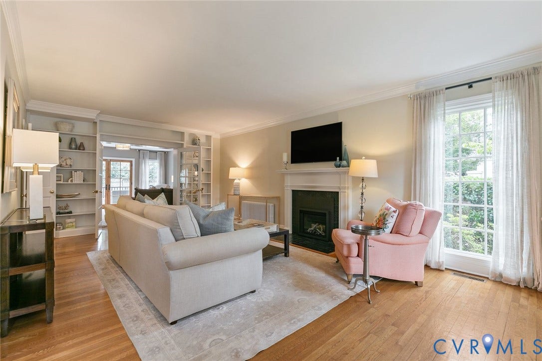 14 Libbie Avenue, Libbie/Grove, Richmond, VA 23226 Living area featuring hardwood flooring, a fireplace with a white mantel, and built-in shelving