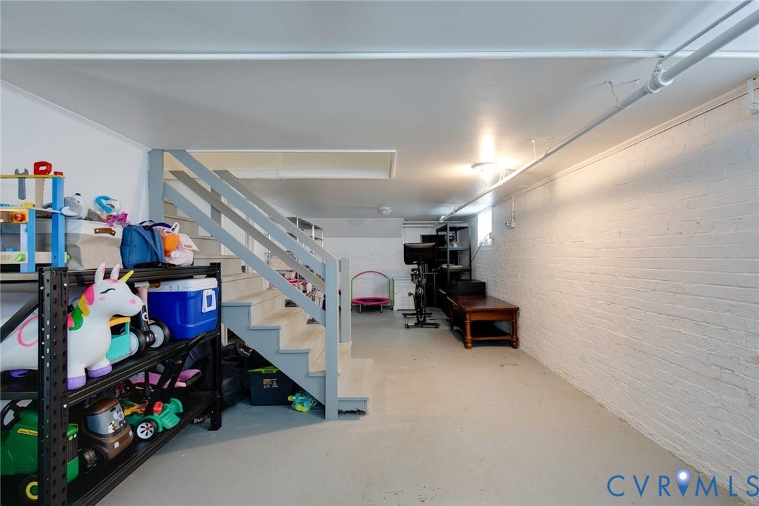 14 Libbie Avenue, Libbie/Grove, Richmond, VA 23226 Finished lower level featuring painted brick walls, exposed ceiling pipes, and a painted staircase with handrails