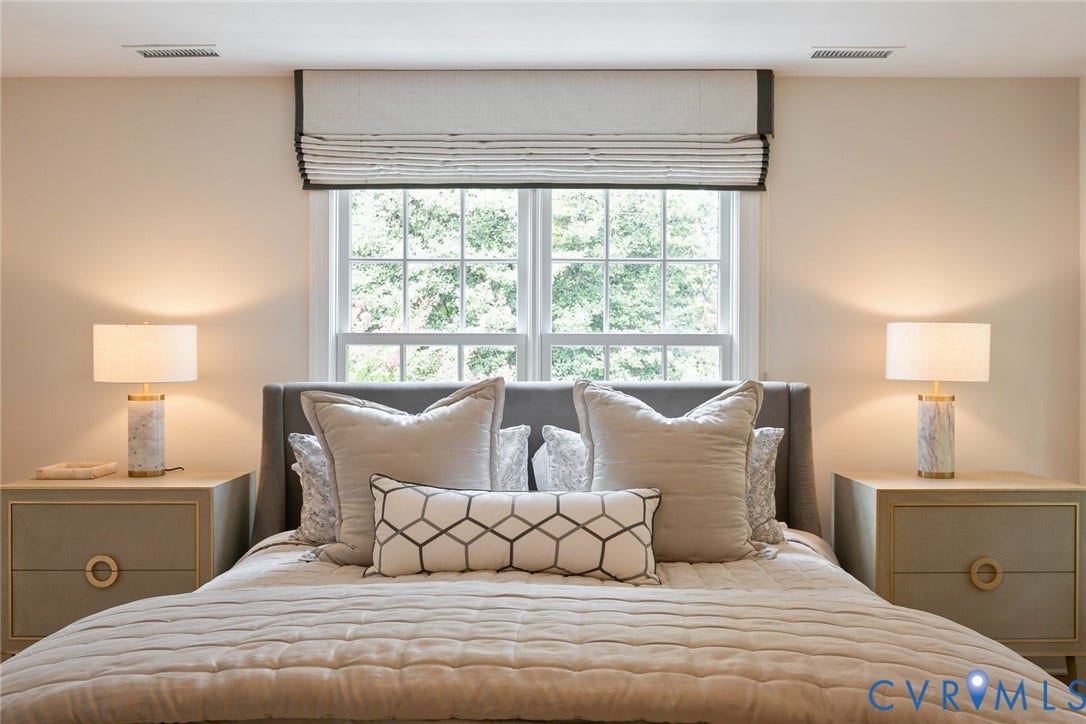 14 Libbie Avenue, Libbie/Grove, Richmond, VA 23226 Window-framed bed with a tufted headboard, flanked by two nightstands featuring gold-tone hardware