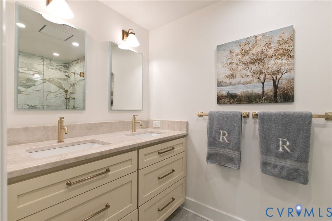 14 Libbie Avenue, Libbie/Grove, Richmond, VA 23226 Double vanity featuring undermount sinks, stone countertops, and brass-finish fixtures
