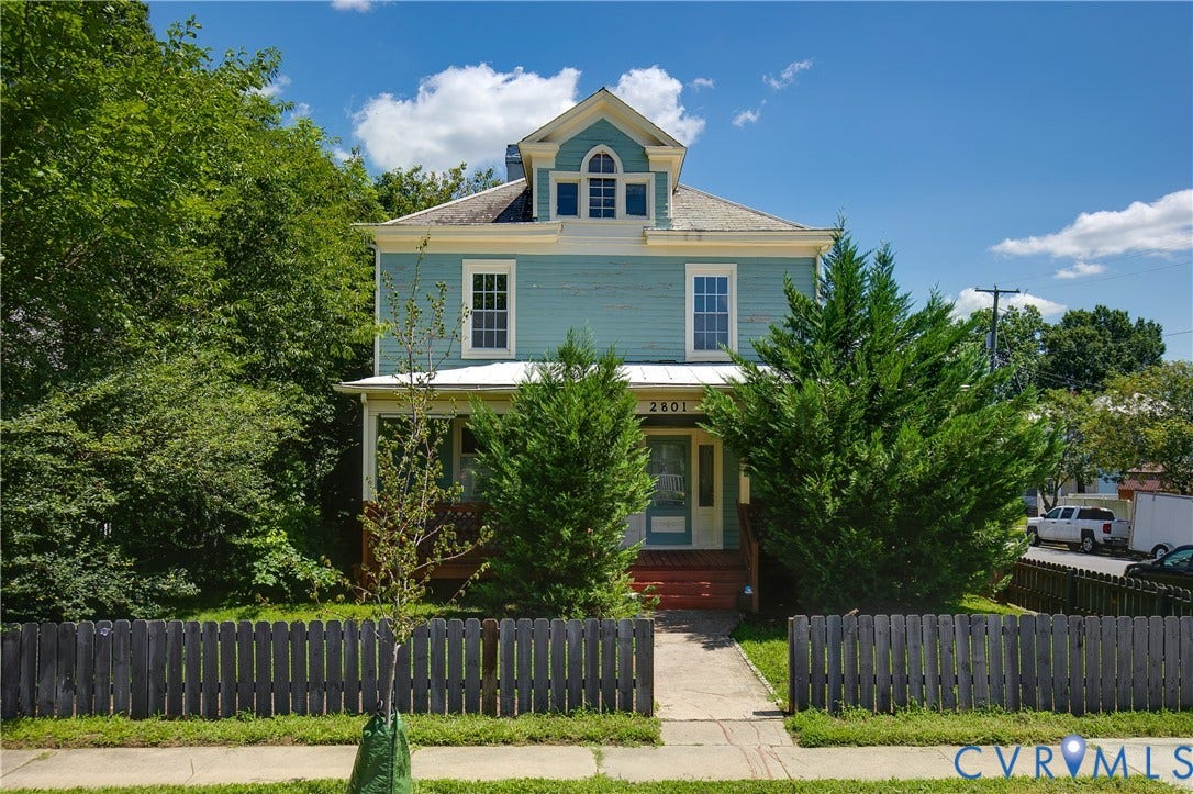 2801 4th Avenue, Richmond, VA 23222 Two-story home featuring light blue siding, a white front porch with red steps, and a dormer window