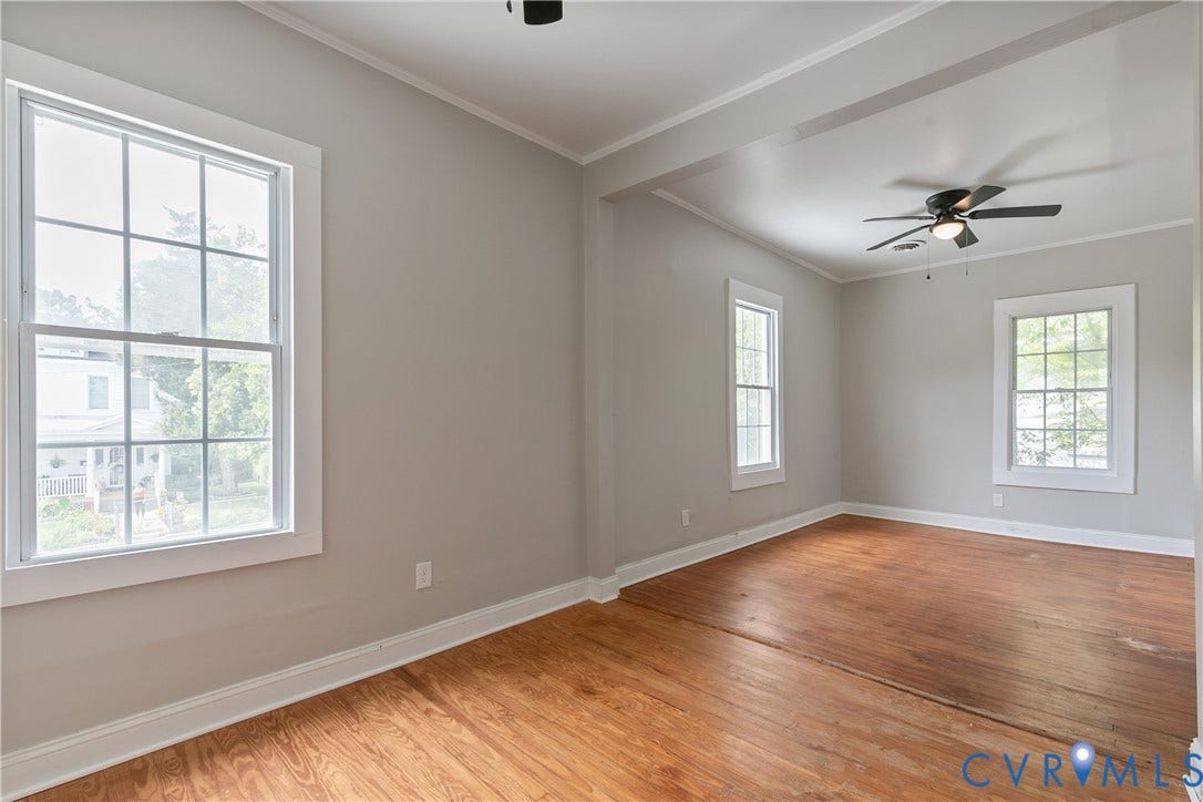 2801 4th Avenue, Richmond, VA 23222 Spacious room featuring wood-finish flooring, light gray walls, white trim, and multiple windows