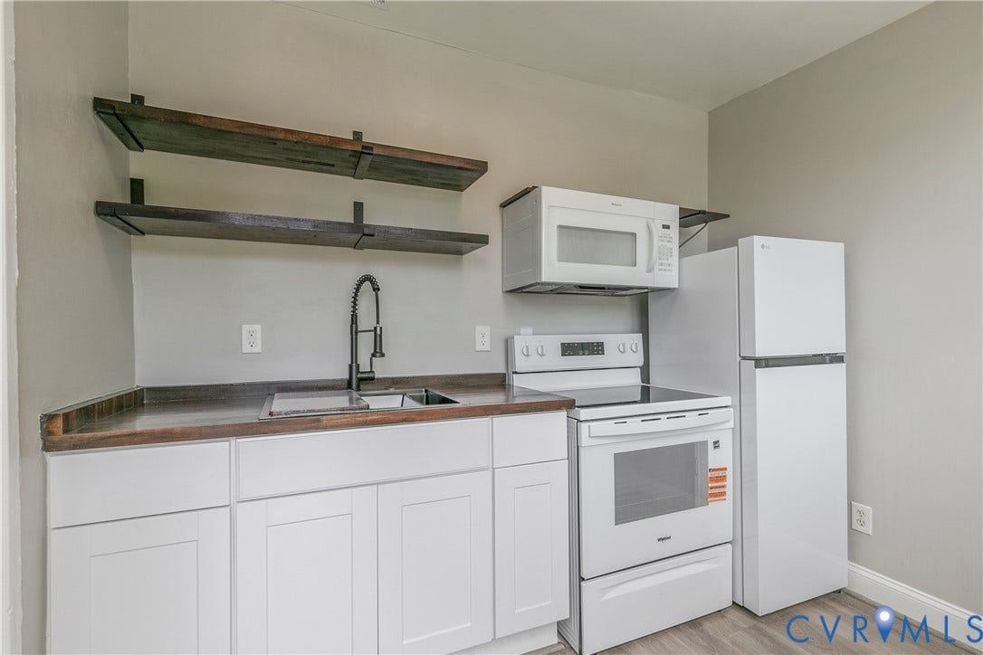 2801 4th Avenue, Richmond, VA 23222 Kitchenette featuring white cabinetry with dark wood-finish countertops, a gooseneck faucet, and stainless steel sink