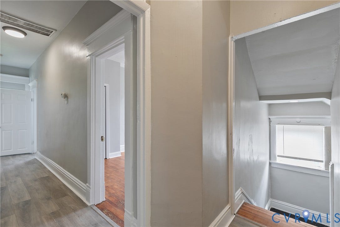 2801 4th Avenue, Richmond, VA 23222 Hallway featuring wood-finish flooring, white trim, a flush-mount ceiling light, and an open doorway