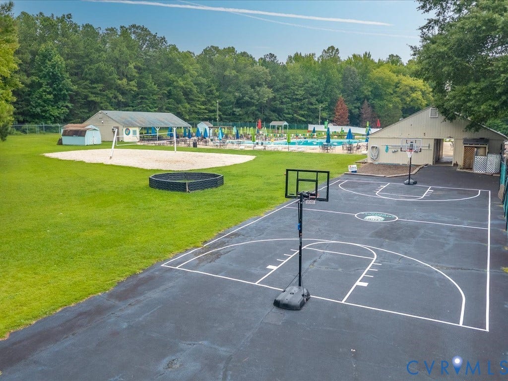 508 Smoketree Place, Chesterfield, VA 23236 Multi-sport court featuring a basketball hoop and painted lines, alongside a sand volleyball court