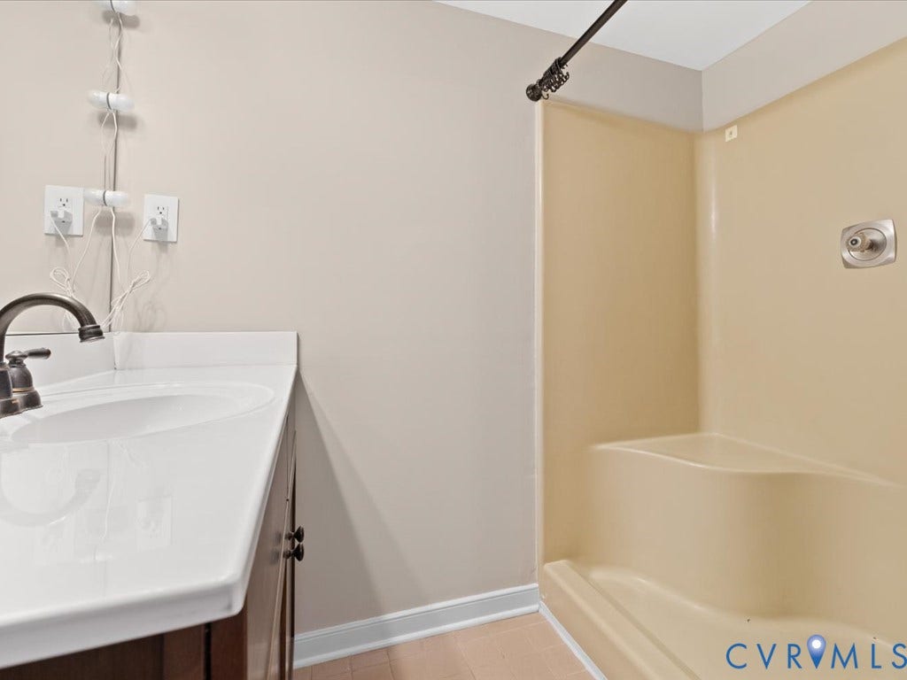 508 Smoketree Place, Chesterfield, VA 23236 En Suite bathroom featuring a white porcelain sink with a dark wood vanity cabinet and shower