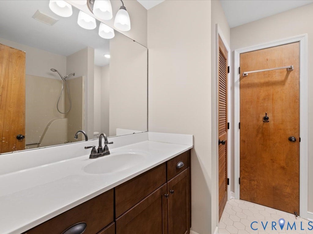 508 Smoketree Place, Chesterfield, VA 23236 Jack and Jill Bathroom featuring a single vanity with a white countertop, dark wood-finish cabinetry.