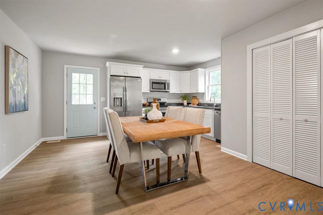 4400 Treely Road, Chesterfield, VA 23831 Open-concept dining area featuring wood-finish flooring, white baseboards, and light gray walls