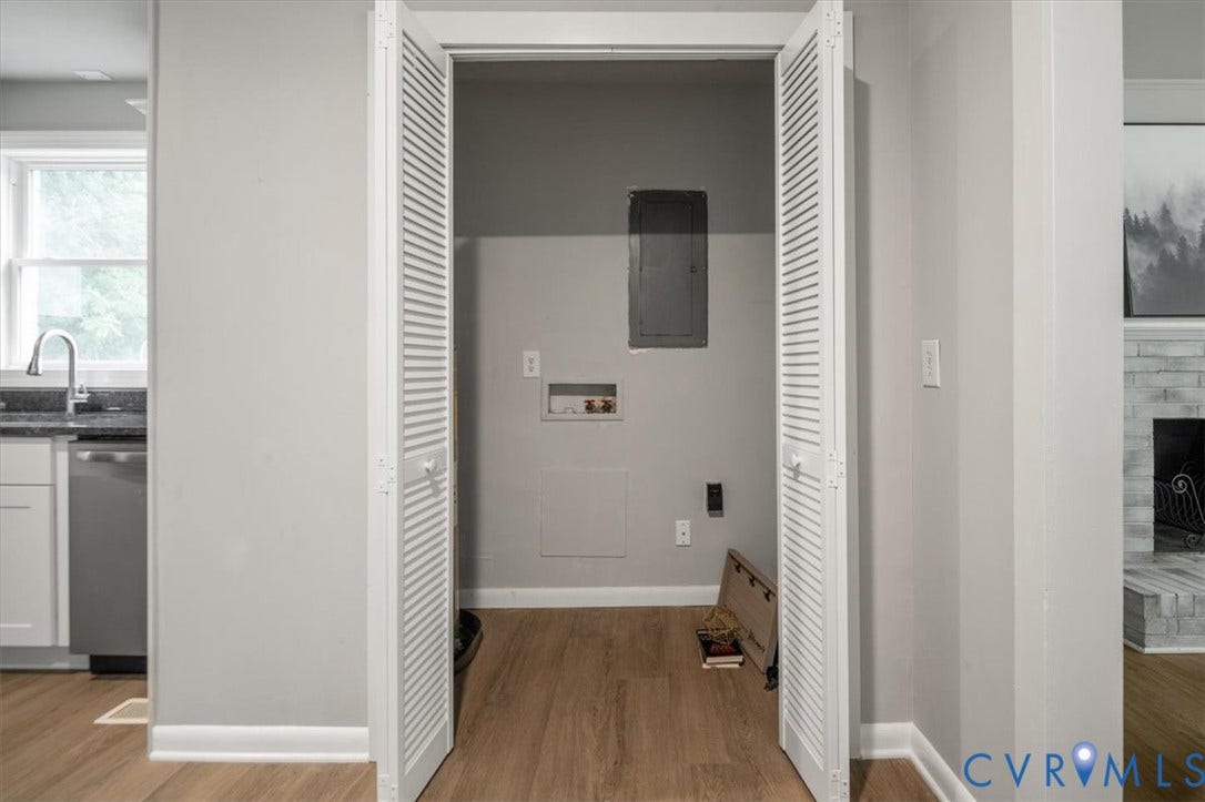 4400 Treely Road, Chesterfield, VA 23831 Utility closet featuring louvered bi-fold doors, wood-finish flooring, and light gray wall paint