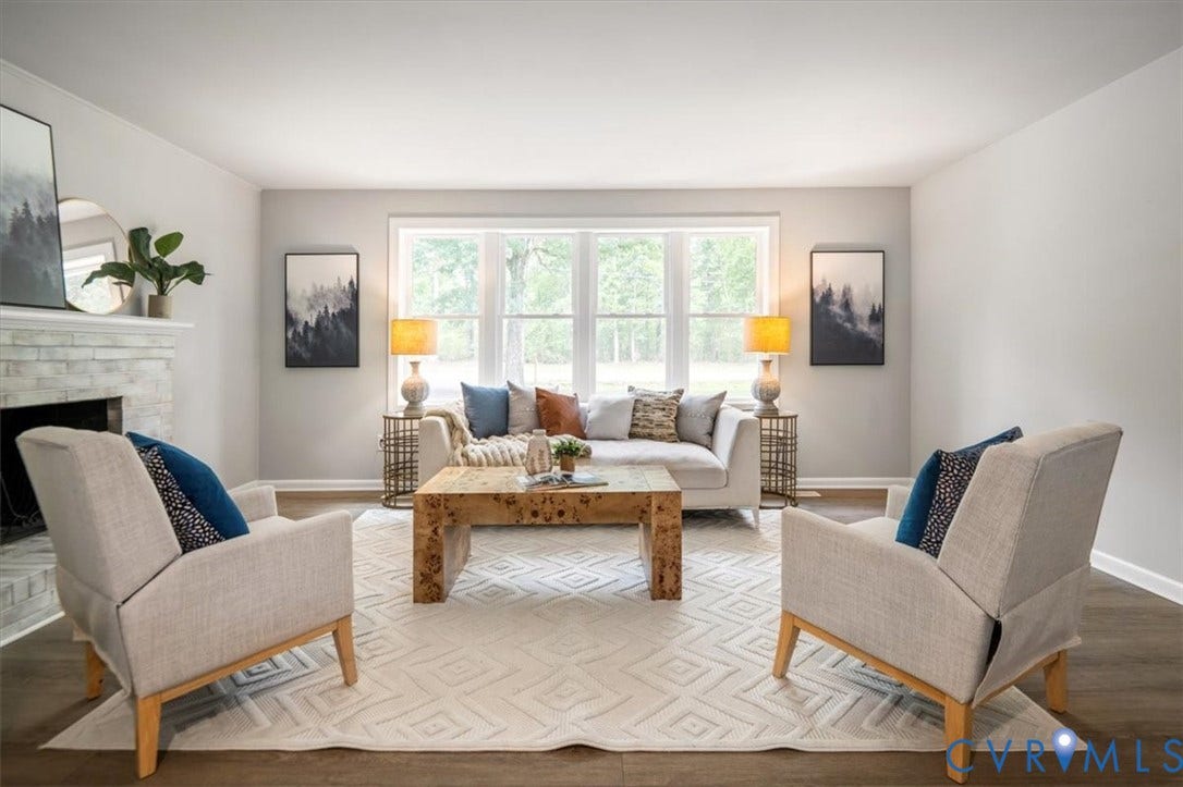 4400 Treely Road, Chesterfield, VA 23831 Spacious living area featuring wood-finish flooring, a white brick fireplace, and a large multi-pane window