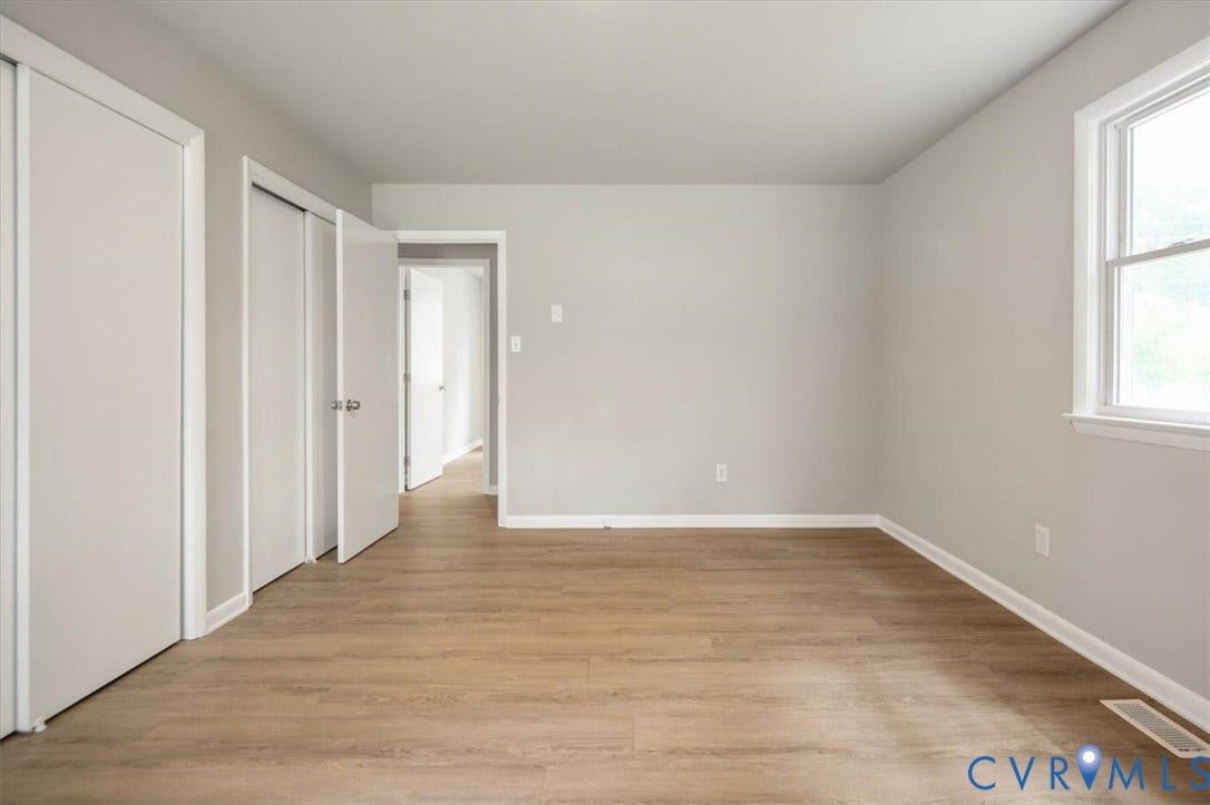 4400 Treely Road, Chesterfield, VA 23831 Bright room featuring wood-finish flooring, light grey walls, white trim, and a double window