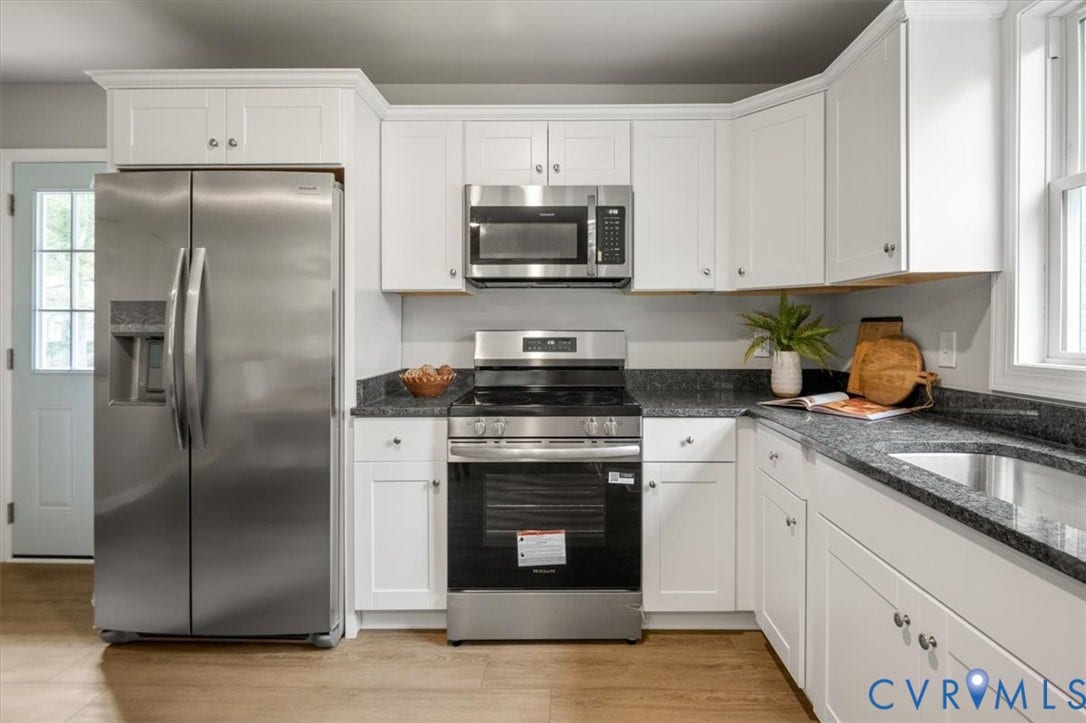 4400 Treely Road, Chesterfield, VA 23831 Kitchen featuring white shaker-style cabinetry, stainless steel appliances, dark granite countertops, and wood-finish flooring