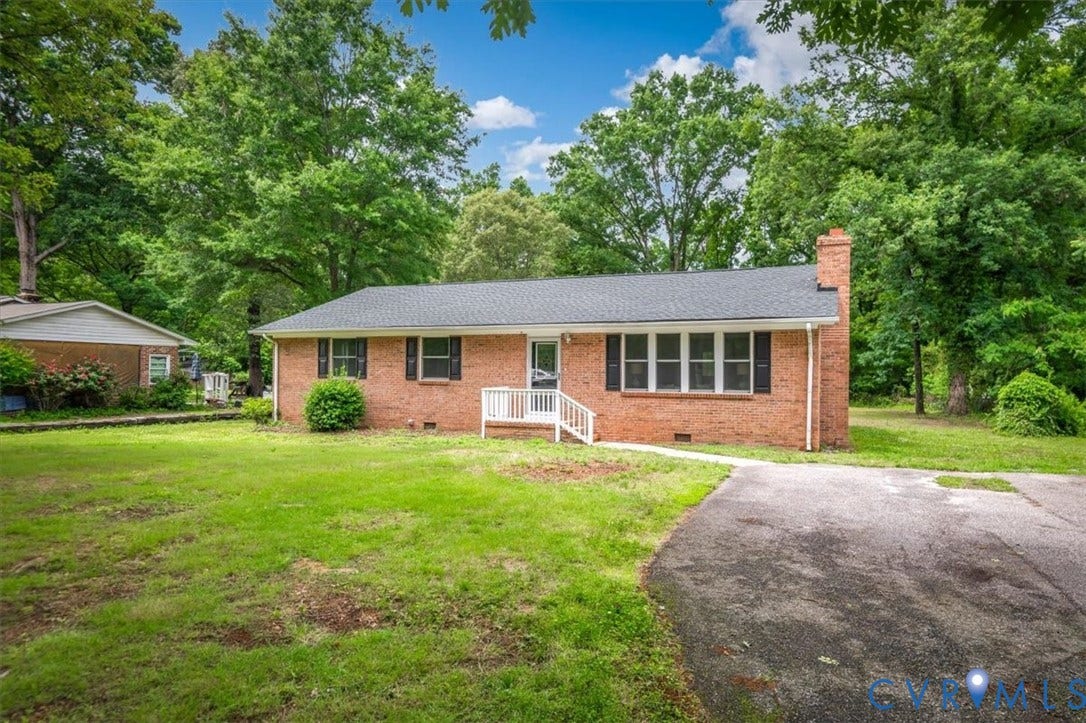 4400 Treely Road, Chesterfield, VA 23831 Brick ranch home featuring a dark shingle roof, white front porch railing, and an asphalt driveway