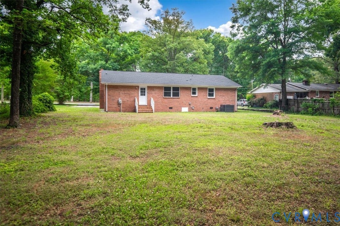 4400 Treely Road, Chesterfield, VA 23831 Expansive rear yard featuring a red brick exterior, mature trees, and a black shingle roof