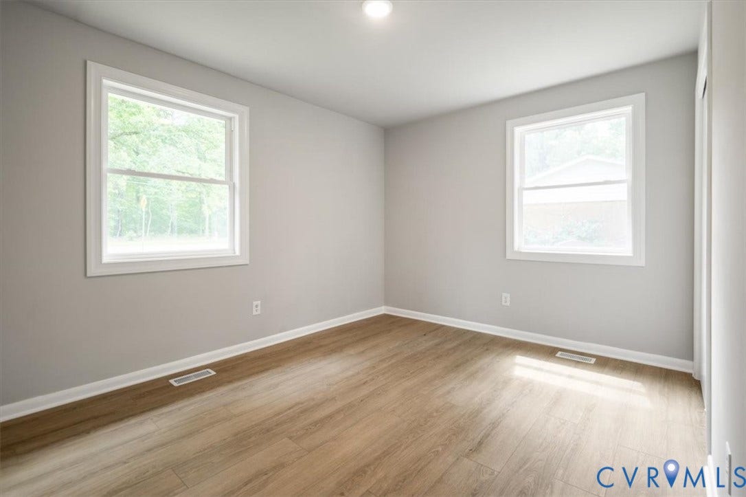 4400 Treely Road, Chesterfield, VA 23831 Spacious room featuring wood-finish flooring, two windows with white trim, light gray painted walls, and a recessed ceiling light