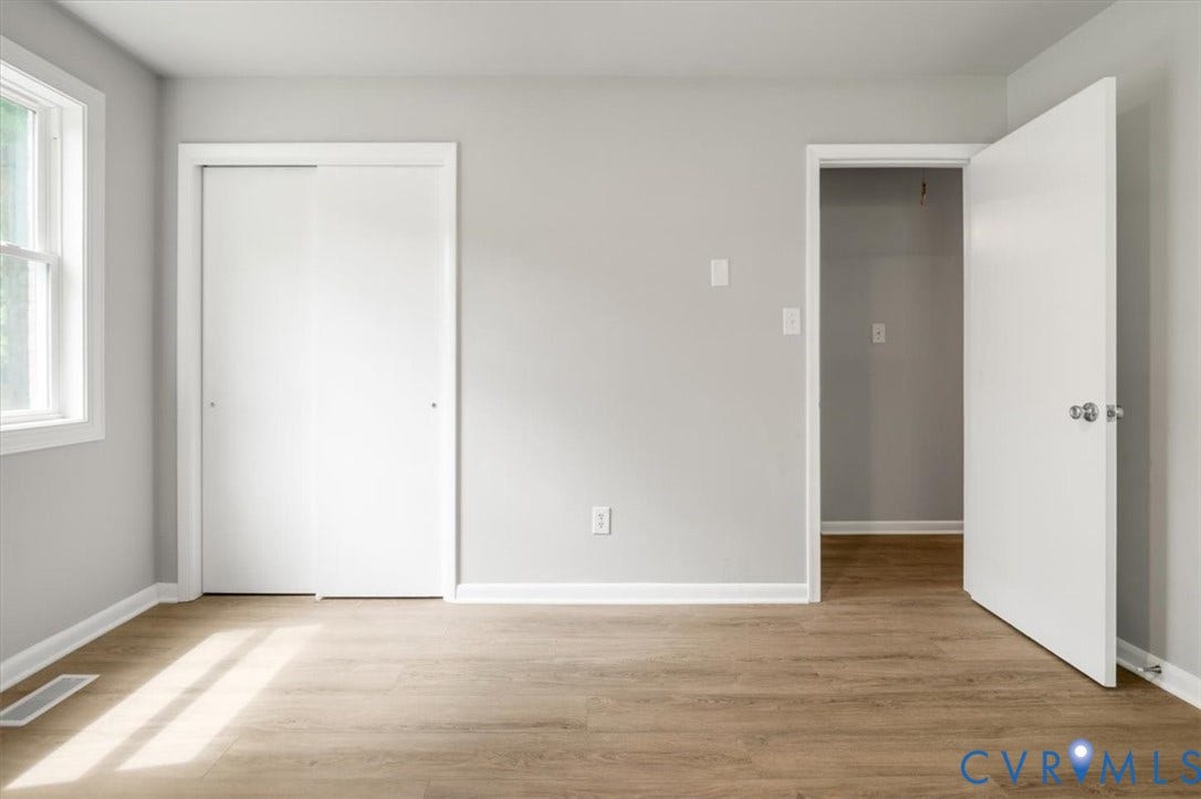 4400 Treely Road, Chesterfield, VA 23831 Spacious room featuring wood-finish flooring, light gray walls, white baseboards, and a white framed window