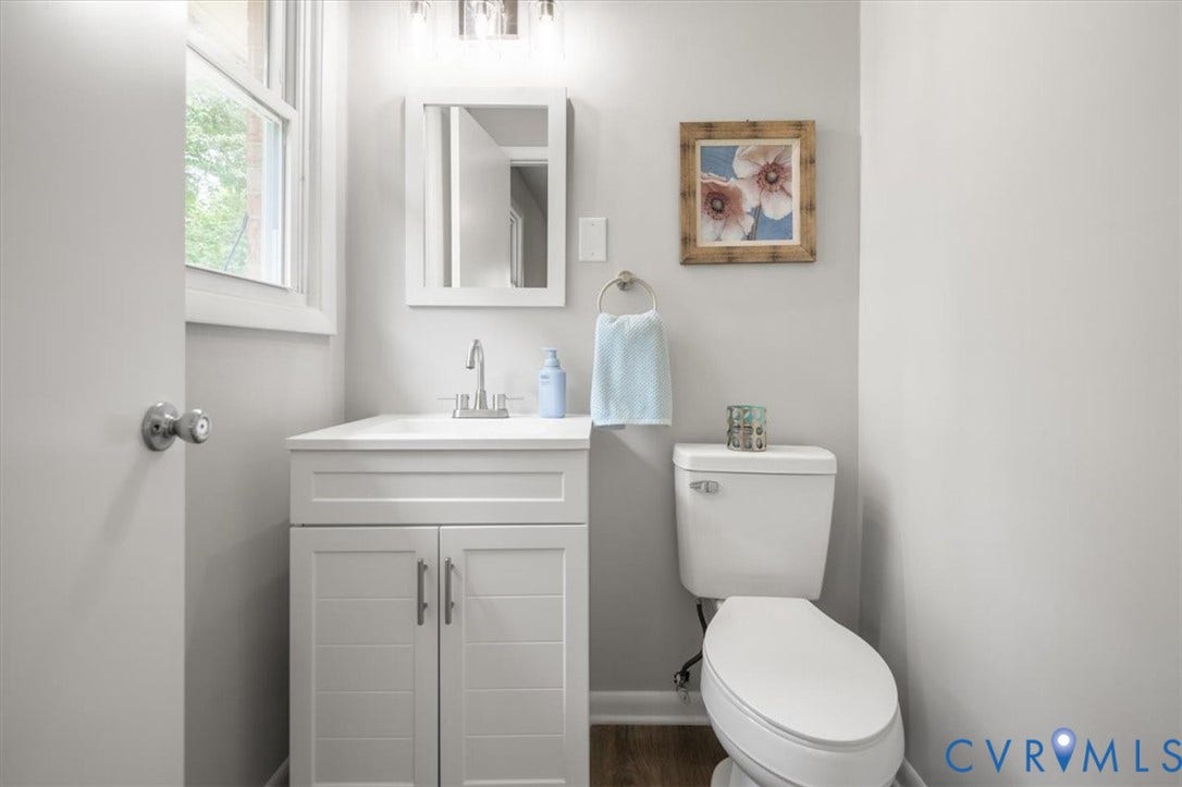 4400 Treely Road, Chesterfield, VA 23831 Bathroom featuring a white vanity with built-in storage, a chrome faucet, a rectangular mirror, and an overhead vanity light fixture
