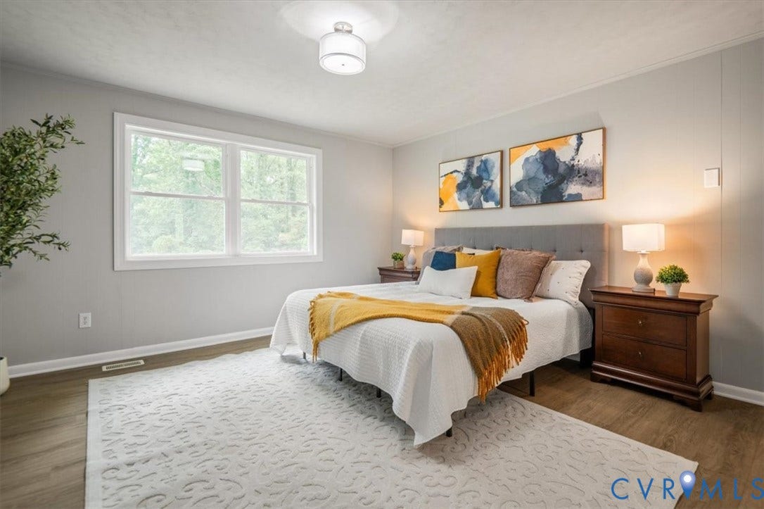 4400 Treely Road, Chesterfield, VA 23831 Spacious room featuring wood-finish flooring, a large window with white trim, and a contemporary ceiling light fixture