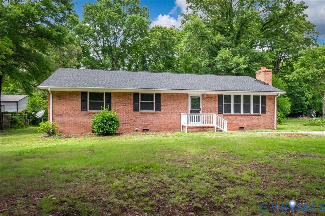 4400 Treely Road, Chesterfield, VA 23831 Brick ranch home featuring a dark shingle roof, white porch railing, and black louvered shutters