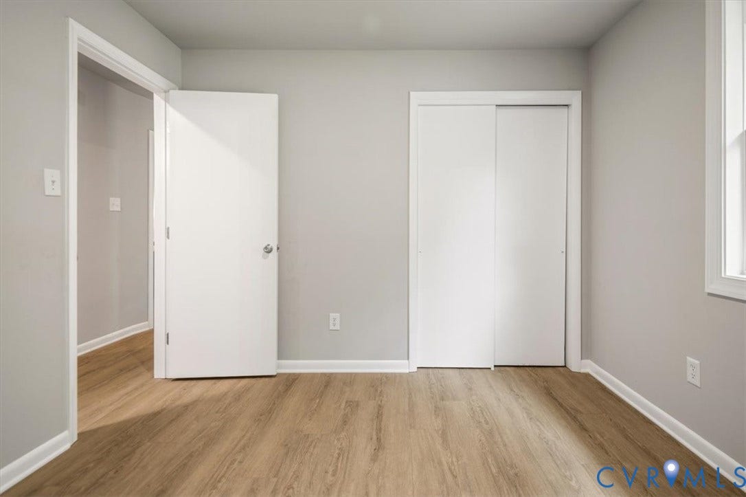 4400 Treely Road, Chesterfield, VA 23831 Room featuring wood-finish flooring, light grey painted walls, white trim, and a white sliding door closet